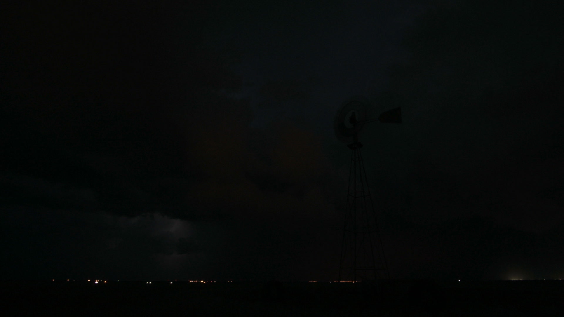 Lightning behind windmill, night, wide shot, Texas, HD. Camera: Sony FS7. Need something else? Contact us at info@stormstock.com