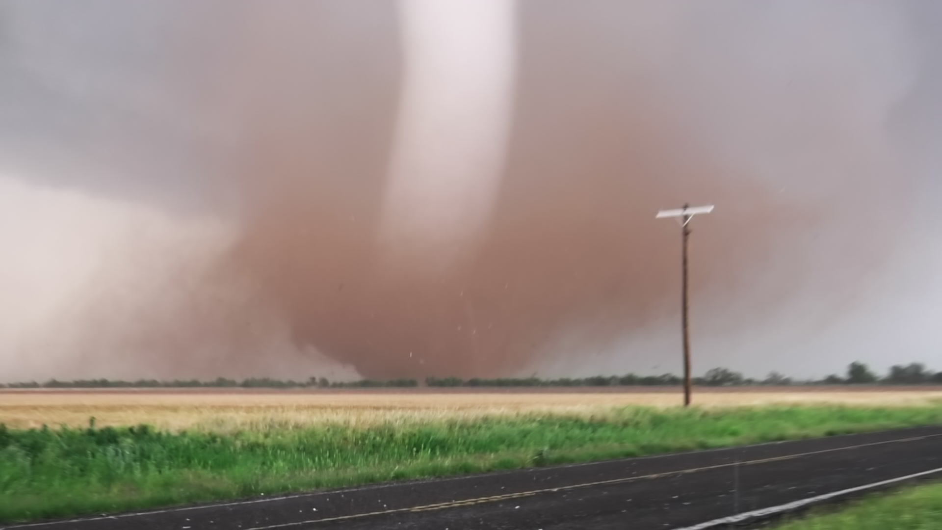 Dramatic Tornado - Tube shaped tornado tracks near Hawley, Texas near rural road, 4K.