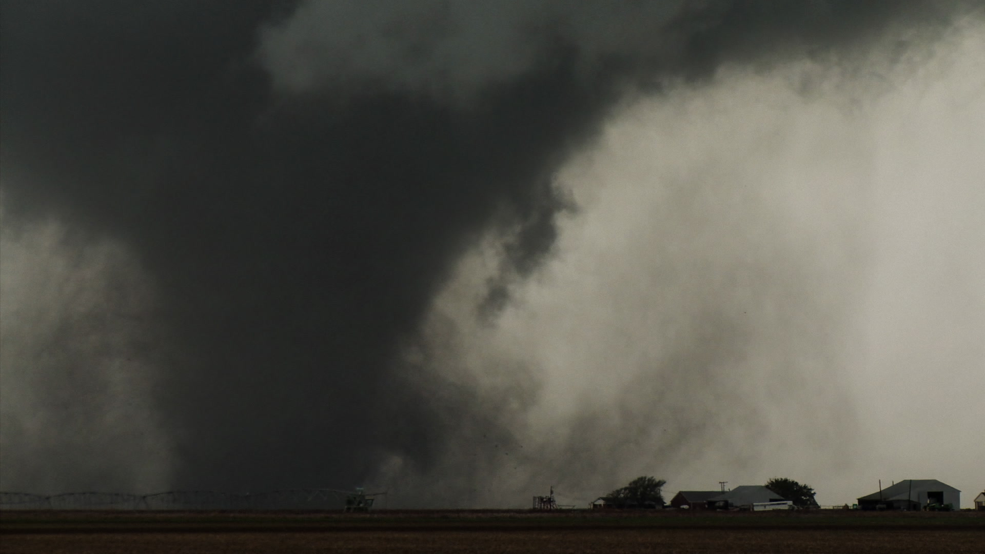 Oklahoma Tornado - Big tornado passes behind farm. Cinematographer: Martin Lisius.