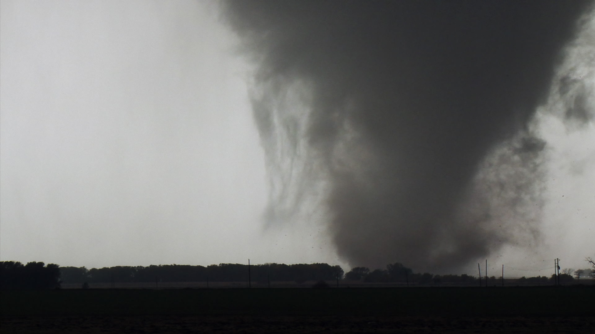 Oklahoma Tornado - Tornado behind trees, travels left to right. Cinematographer: Martin Lisius.
