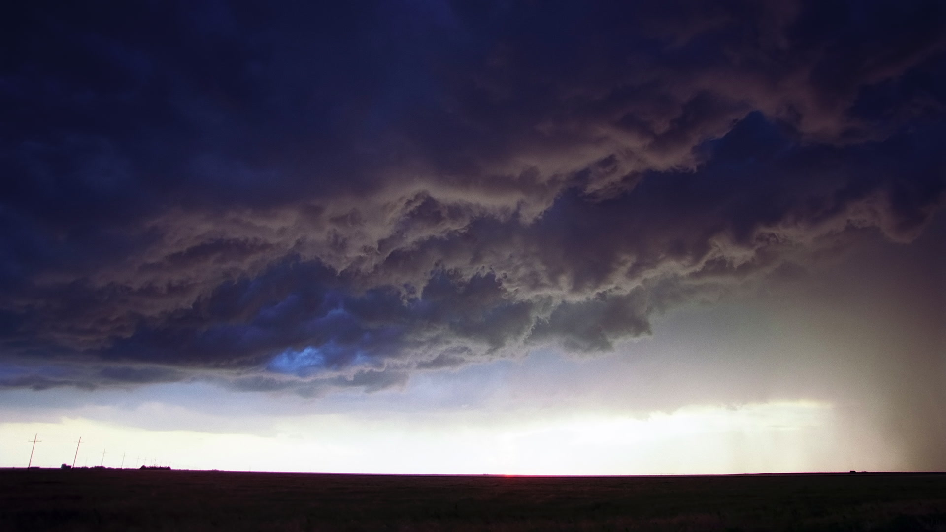 Storms on 35 - Amazing, inky storm clouds swirl above prairie at sunset, Texas. Super 35mm film to 4K video. Cinematographer: Martin Lisius. Need more? Give us a shout!