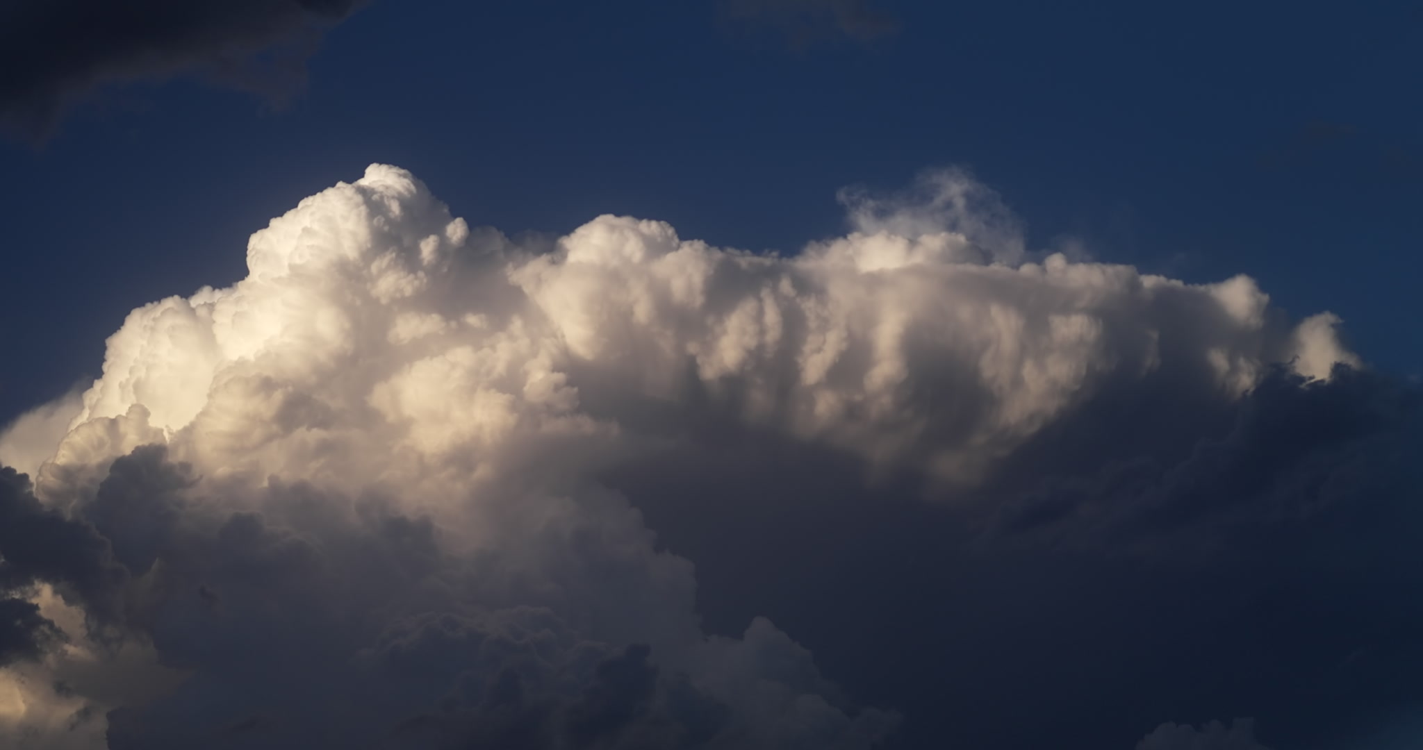 4K Storm Clouds - Tall thunderstorm lit by setting sun. Cinematographer: Martin Lisius.