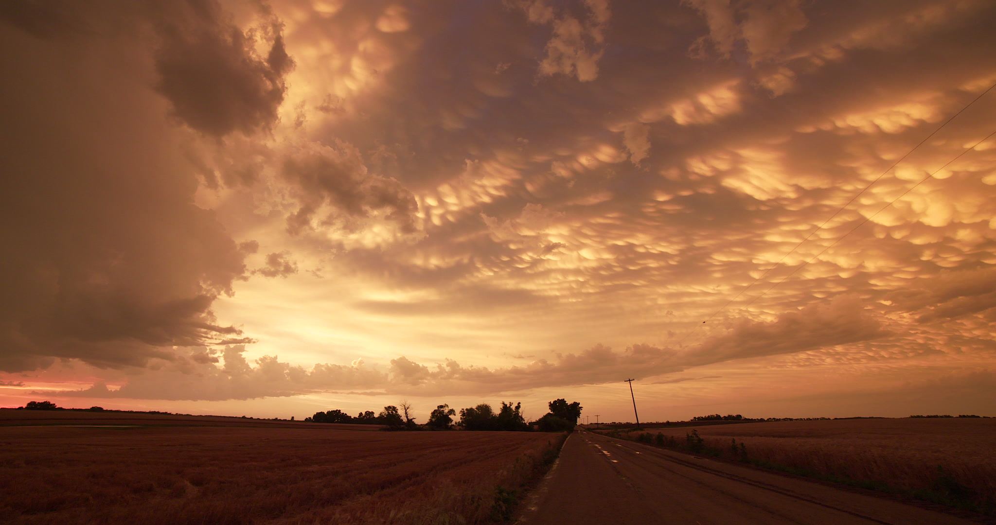 Beautiful mammatus clouds at sunset, pan left, Kansas, 4K. Cinematographer: Martin Lisius.