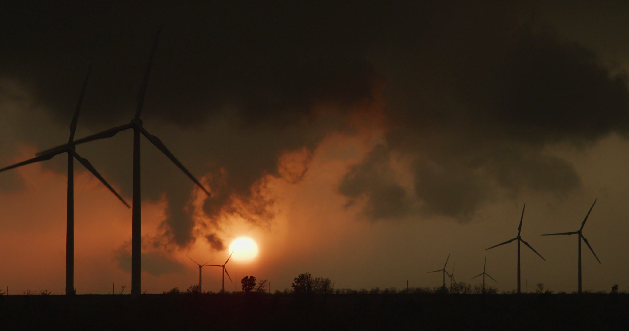 Storm clouds clear over sunset and wind farm, 4K. Cinematographer: Martin Lisius.