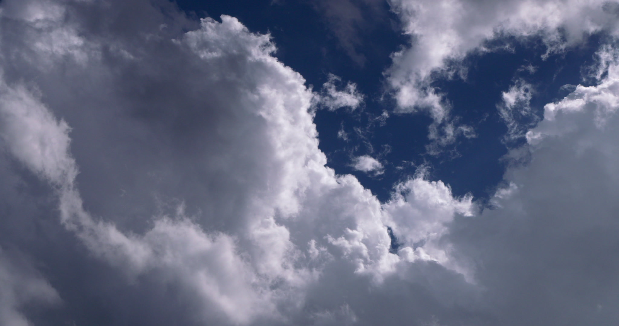 Storm clouds build upward in blue sky, DCI 4K. Cinematographer: Martin Lisius.