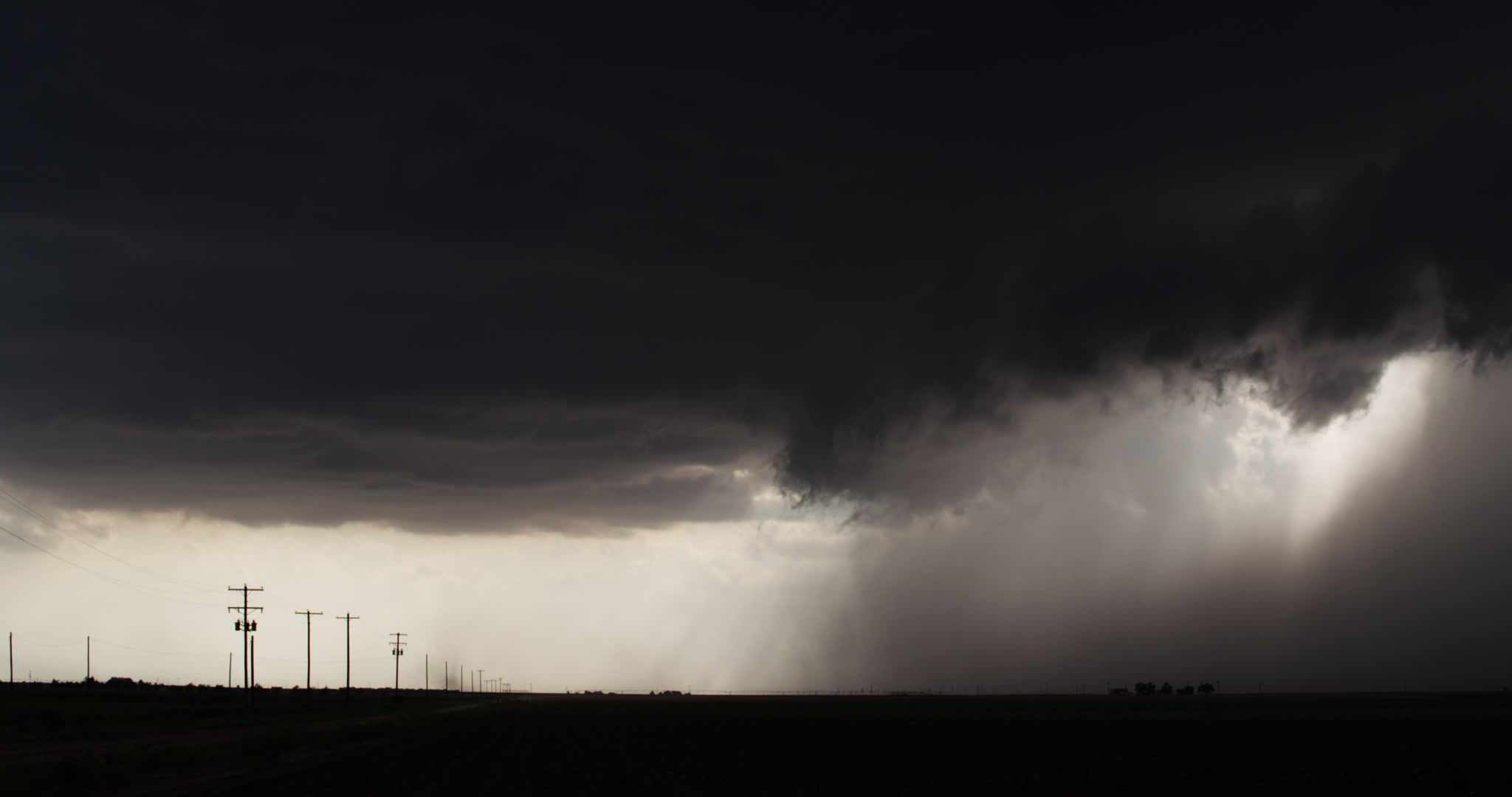 Storm clouds - Dark clouds drift toward rural highway, 4K. Cinematographer: Martin Lisius. DCI 4K. Need more storm shots? Contact us.