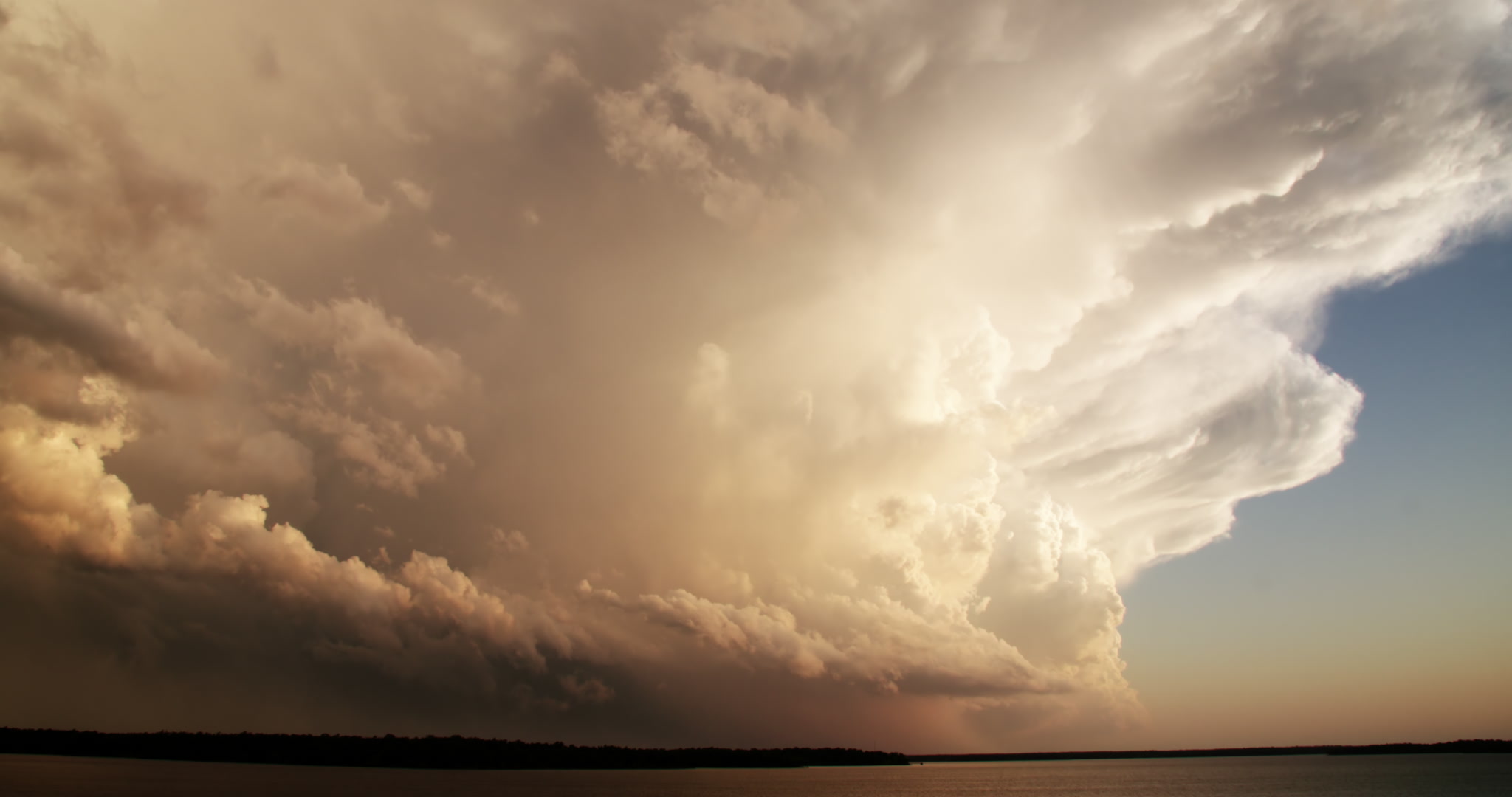 Storm clouds - Large, golden thunderstorm over lake, late day, time-lapse, 4K. Cinematographer: Martin Lisius. Need more cinematic-quality storm shots? Please contact us.