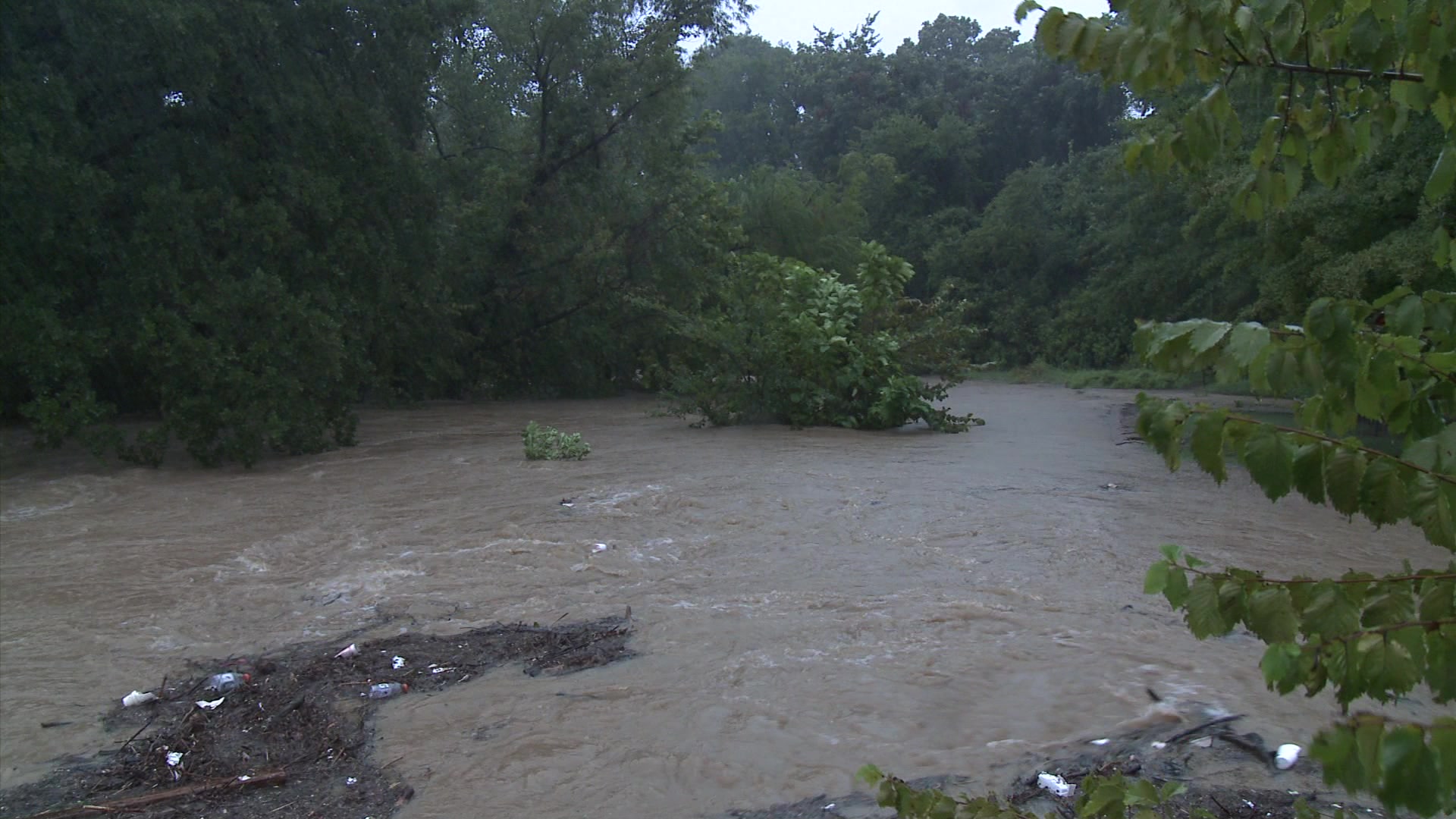 Urban flooding - Creek overflowing with storm runoff, HD.