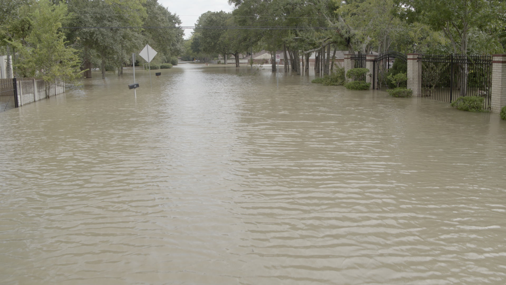 Hurricane Harvey - Low aerial shot of flooded residential street, 4K. Contact us to see more Hurricane Harvey footage.