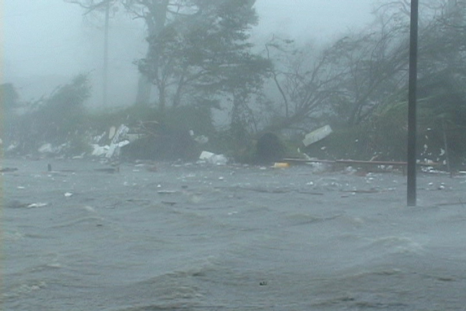 Big wind and waves flow past debris, Hurricane Katrina,