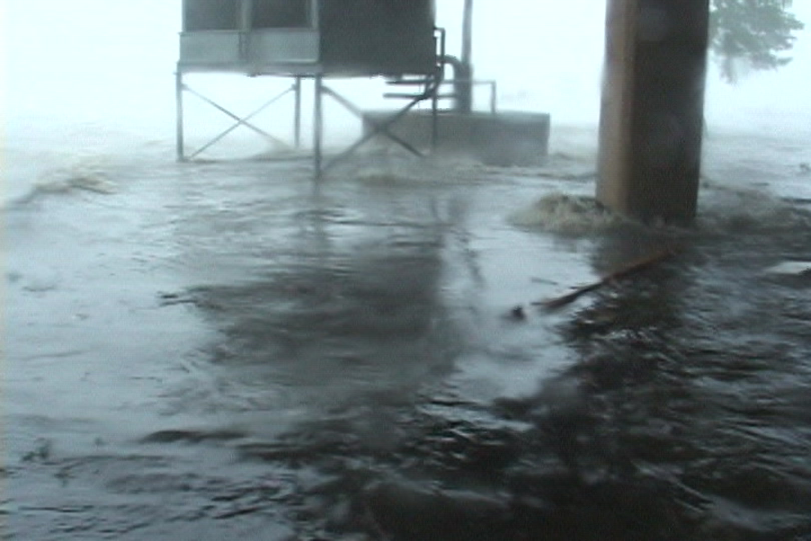 Big waves rush in and threaten man, Hurricane Katrina.