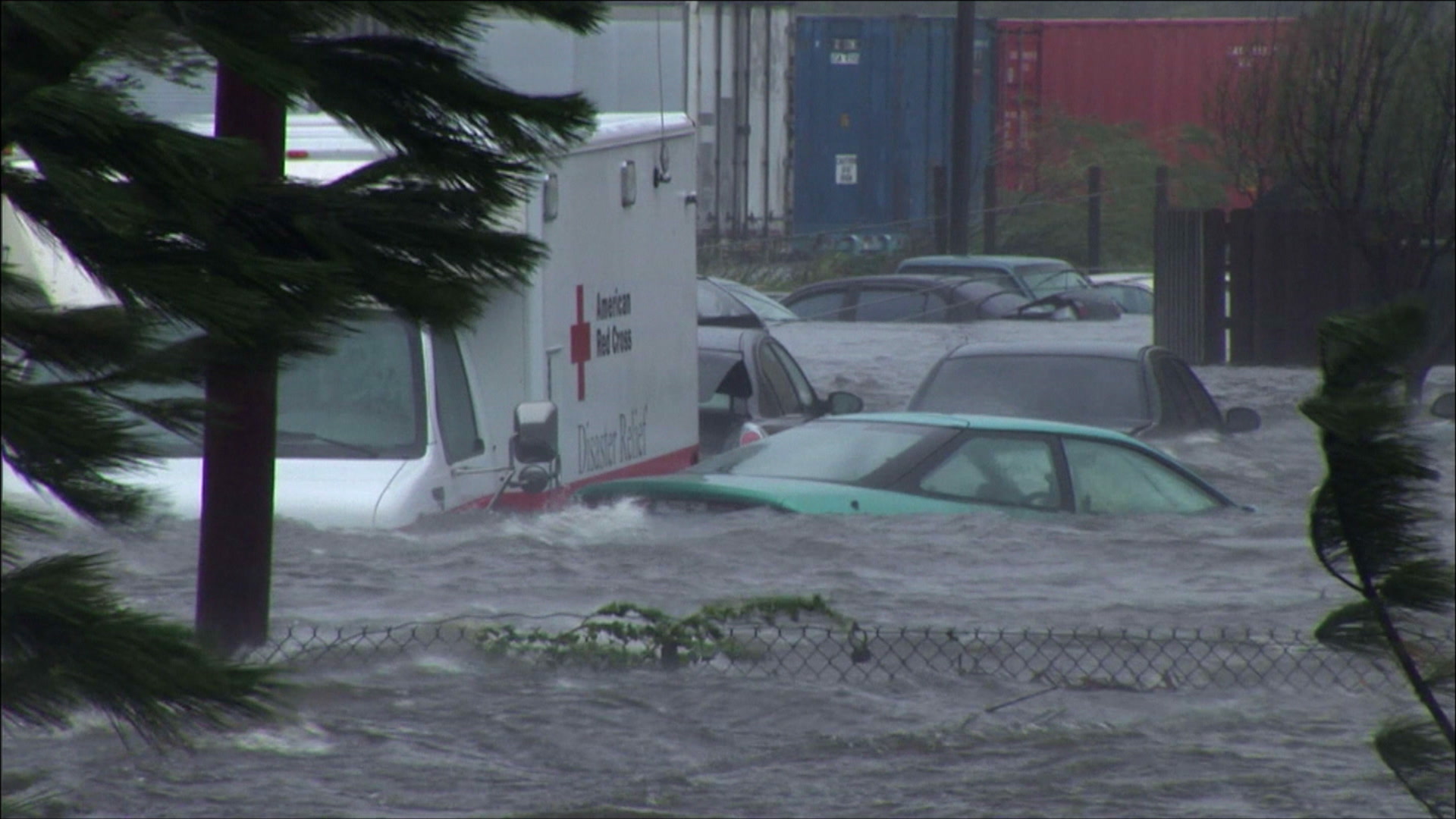 Intense wind, storm surge roll past flooded cars and Red Cross truck, Hurricane Katrina, 4K video. Cinematographer: Martin Lisius.
