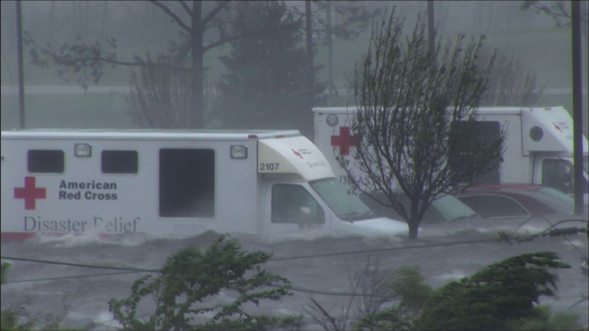 Dramatic panning shot of parking lot, cars, hotel, caught in storm surge, Hurricane Katrina, 4K. Cinematographer: Martin Lisius.