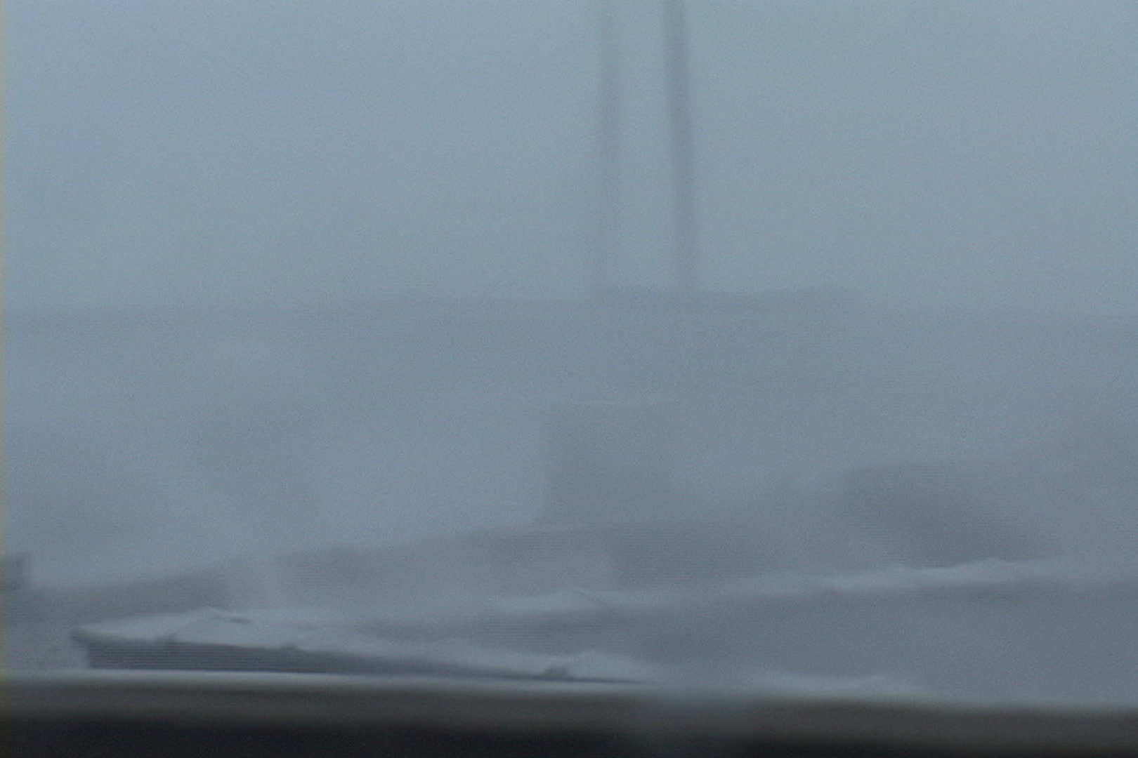 Intense wind and rain blow across rooftop during Hurricane Katrina.
