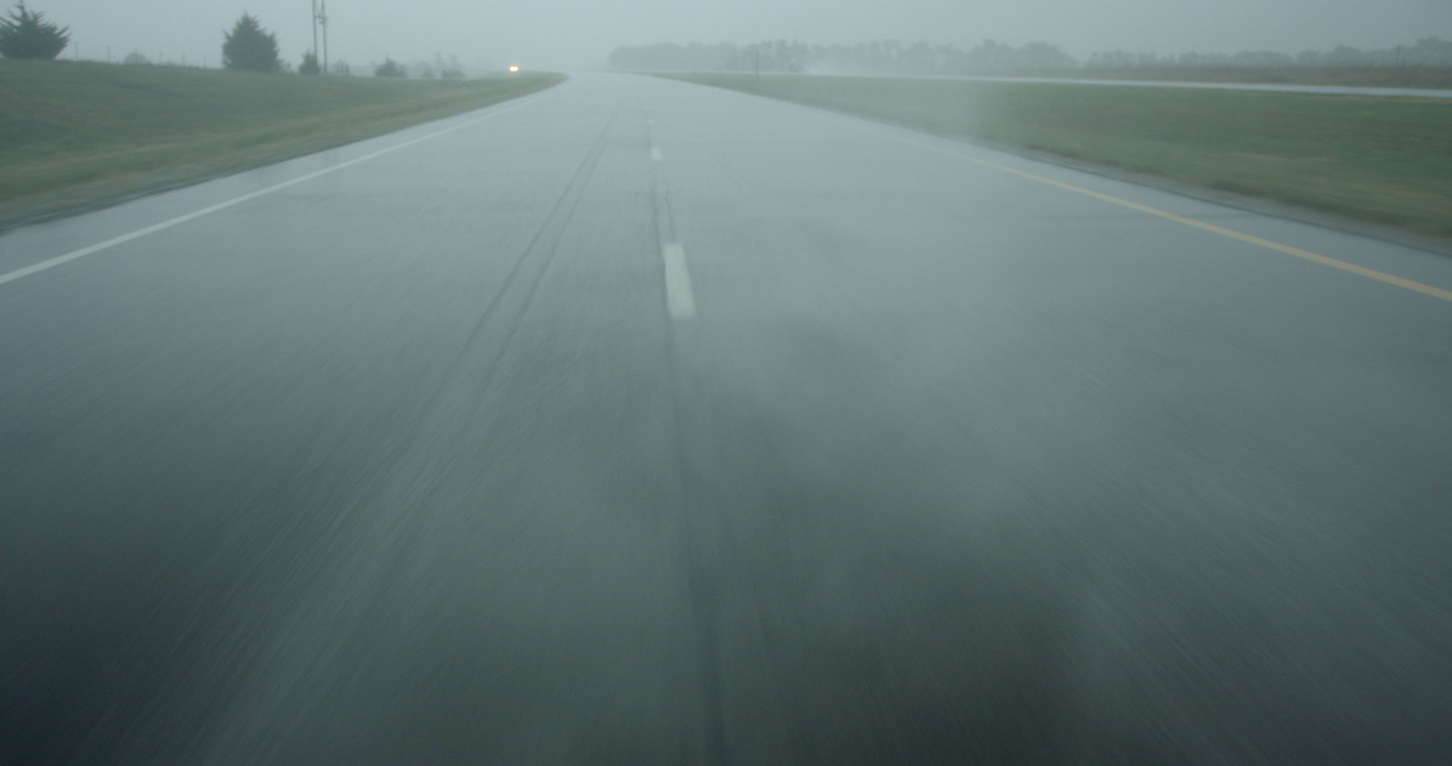 Driving down rainy highway, car POV, looking back, 4K. Cinematographer: Martin Lisius. Camera: RED DSMC Dragon 5K.