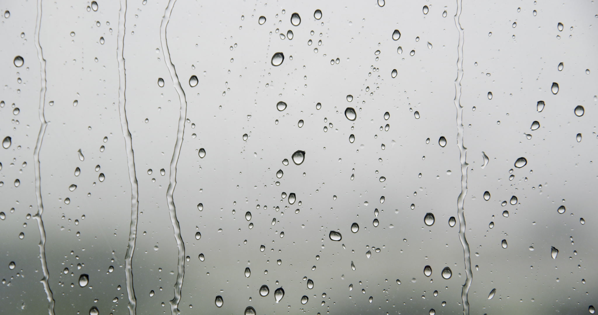 Close-up of rain drops on window, day, 4K. Cinematographer: Martin Lisius. Camera: RED DSMC Dragon 5K.