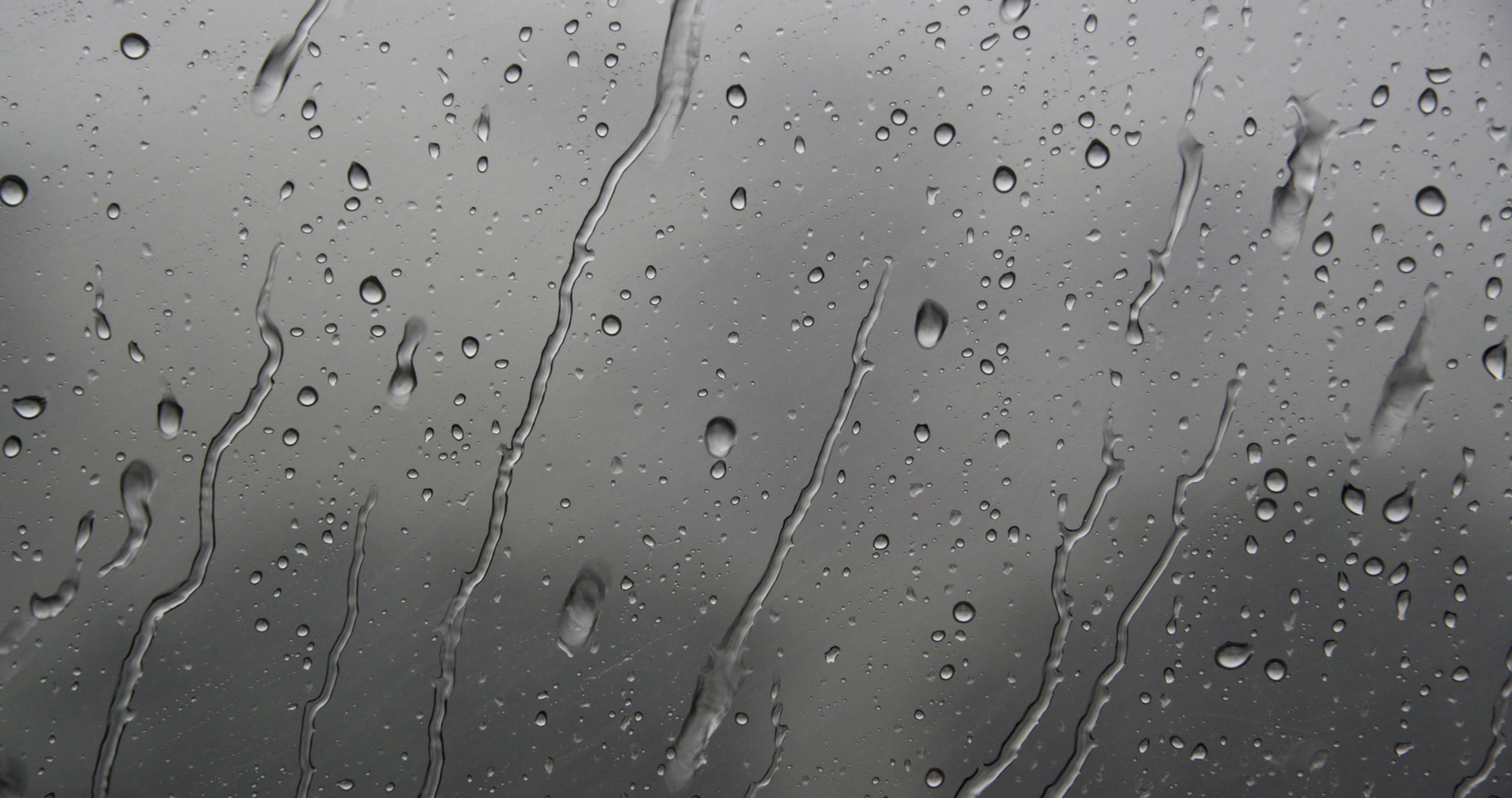 Close-up of rain flowing down window, day, 4K. Cinematographer: Martin Lisius. Camera: RED DSMC Dragon 5K.