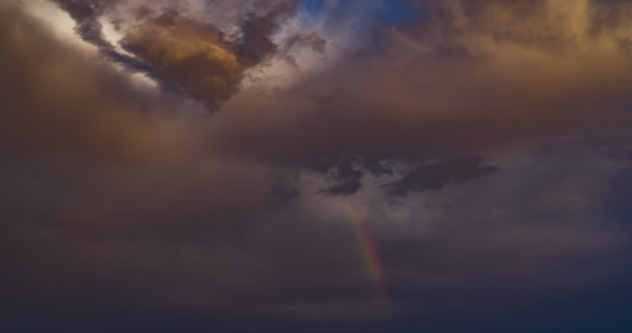 Rainbow time-lapse, stormy sky sequence. DCI 4K.