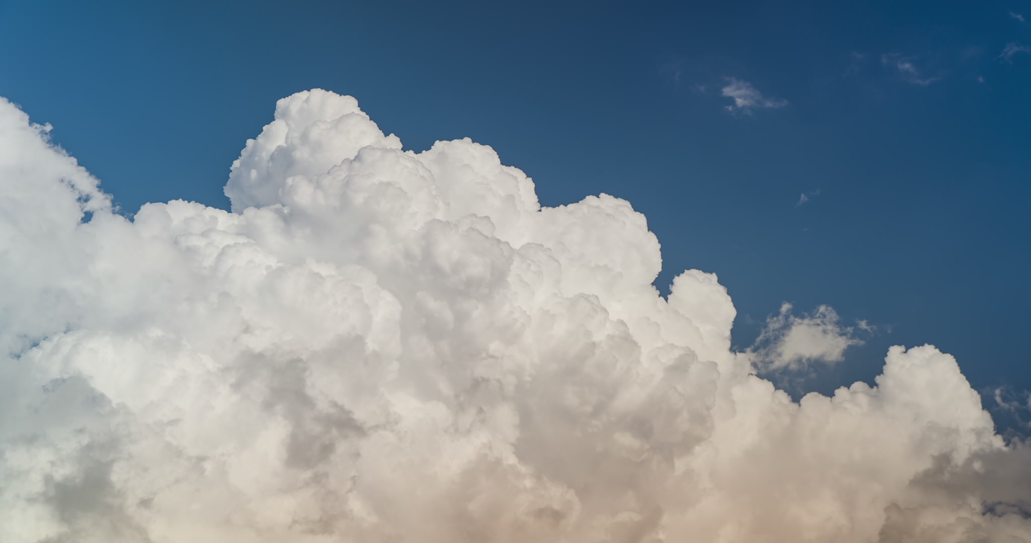 Big, bright towering cumulus clouds in blue sky, building storm, real-time. DCI 4K.