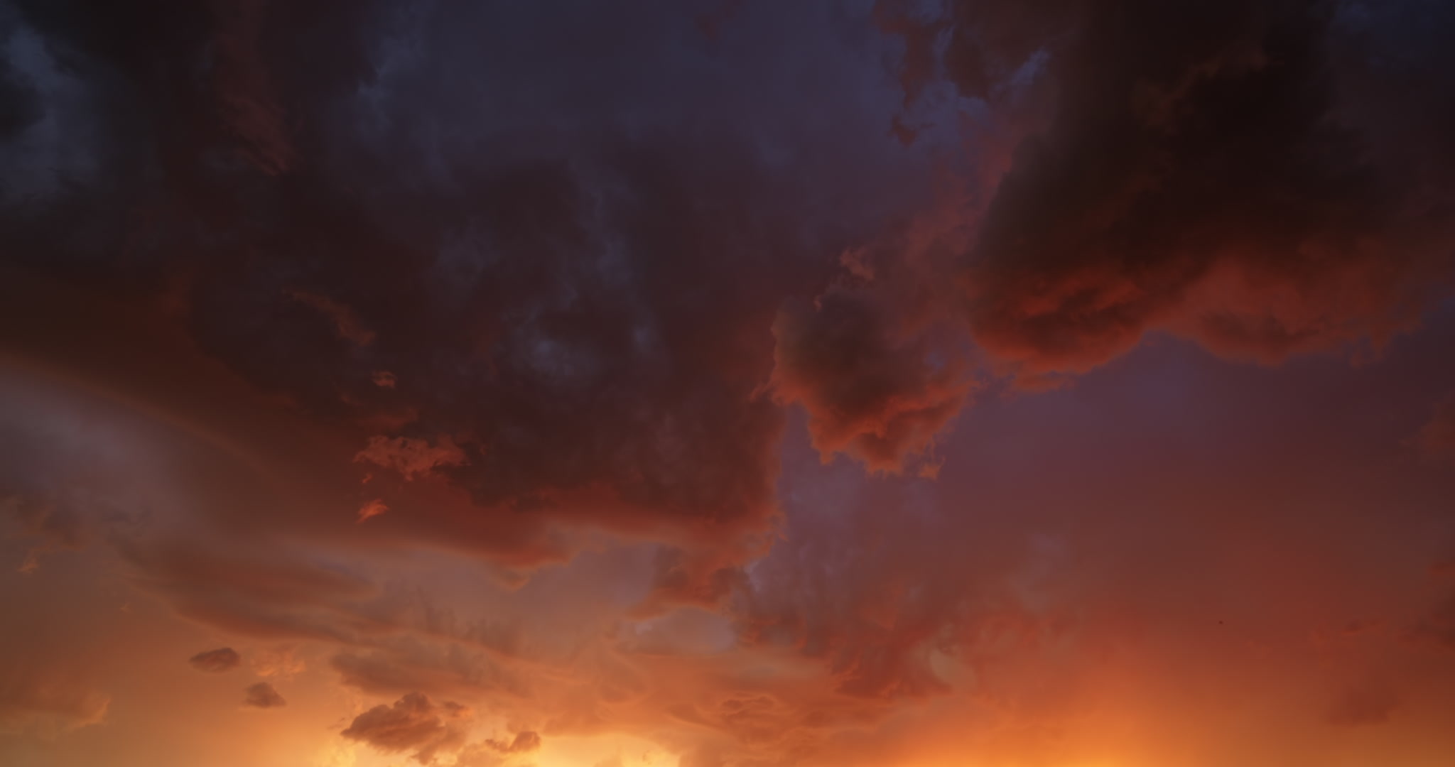 Time-lapsed, beautiful orange, stormy sky with lightning. DCI 4K.