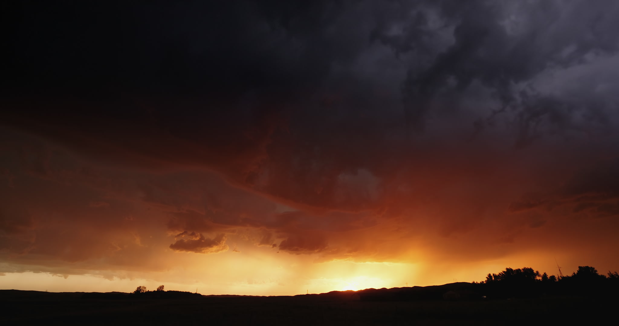 Orange stormscape with forked lightning, setting sun, Nebraska sand hills, 4K. DCI 4K.