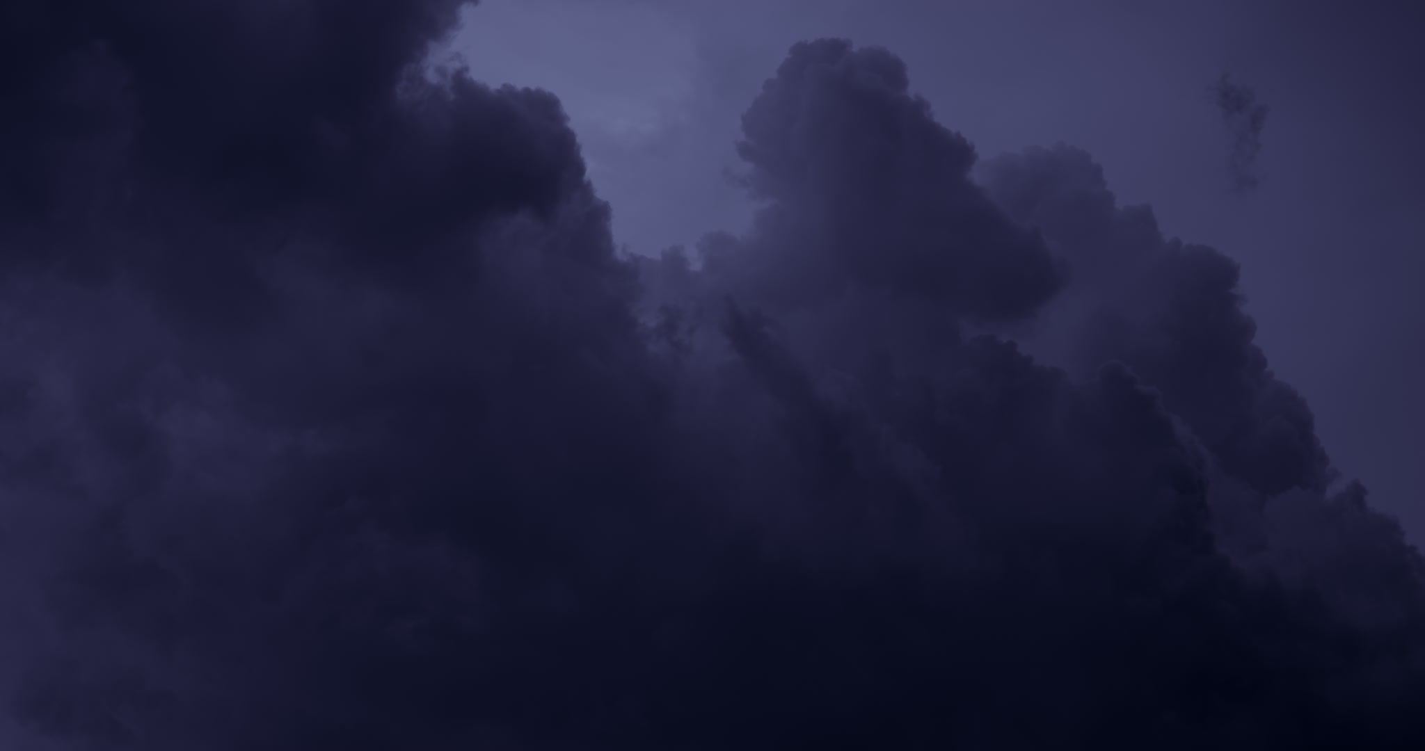 Dark storm clouds build upward at night, DCI 4K.