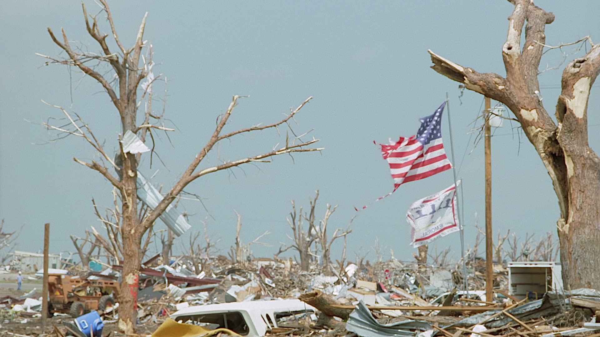 Tornado damage and aftermath - American flag flies over destruction, Greensburg EF5 aftermath, 35mm film to 4K.