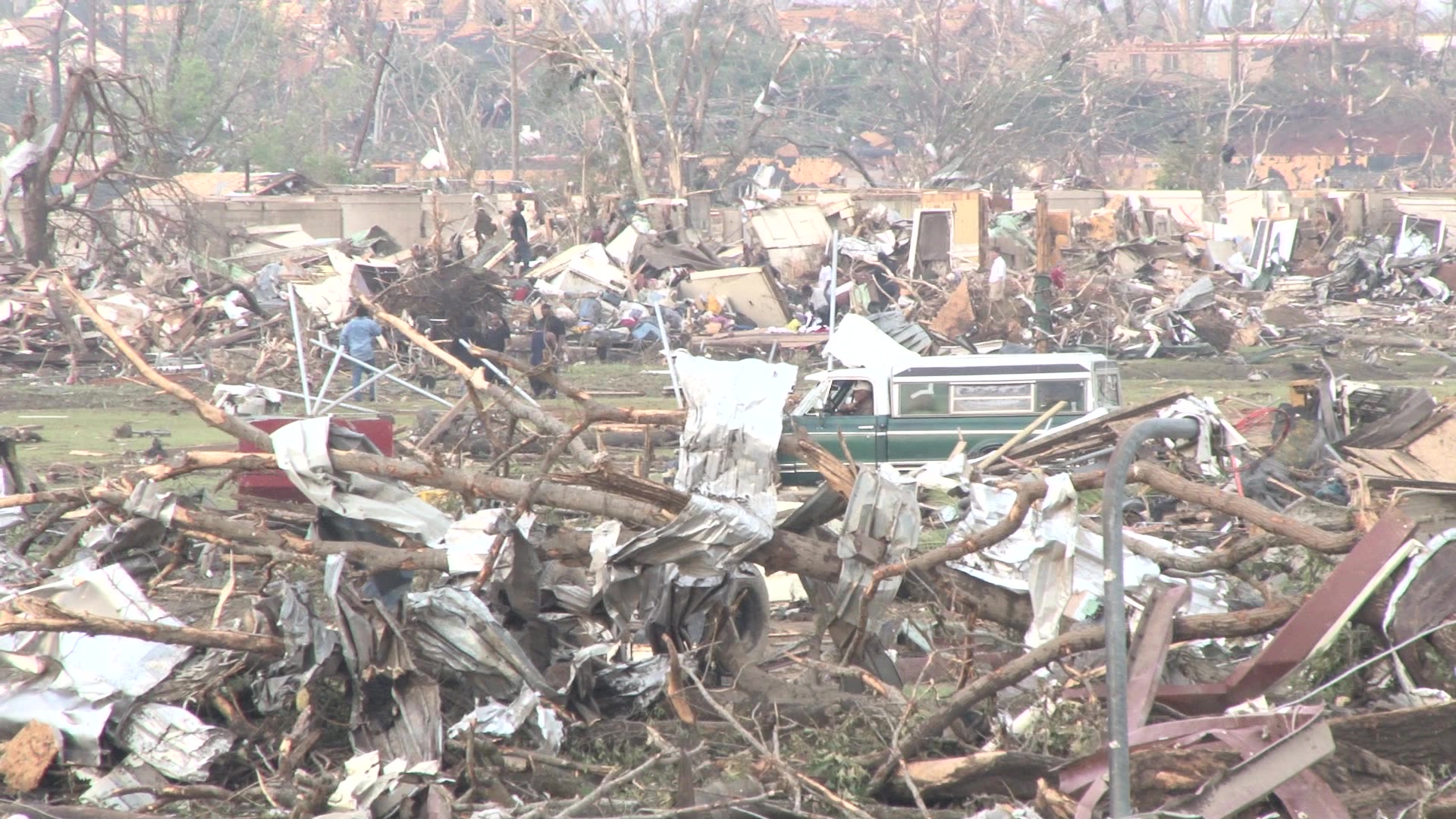Tornado damage and aftermath - Pan of totally destroyed town.