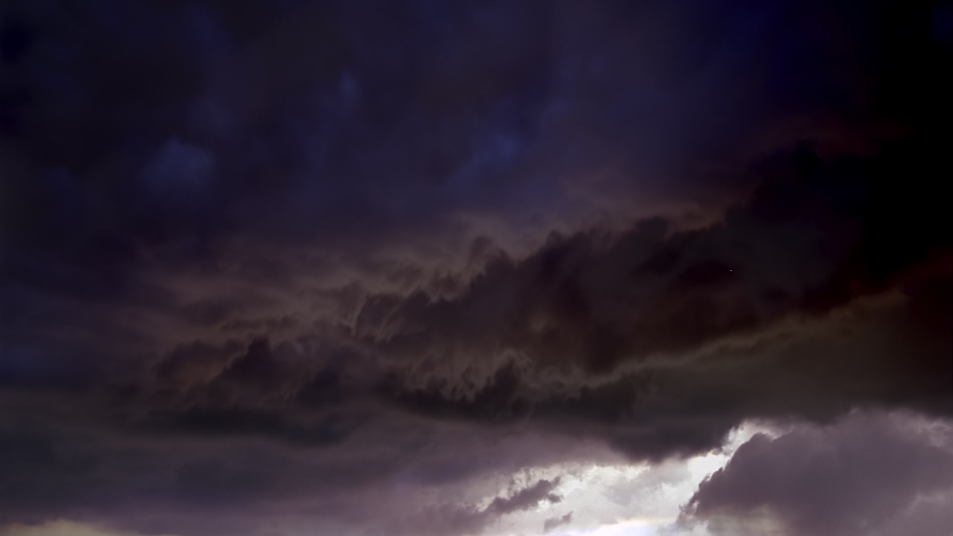 Dark gray storm clouds swirl at dusk, sky only - Super 35mm film to HD 1080.