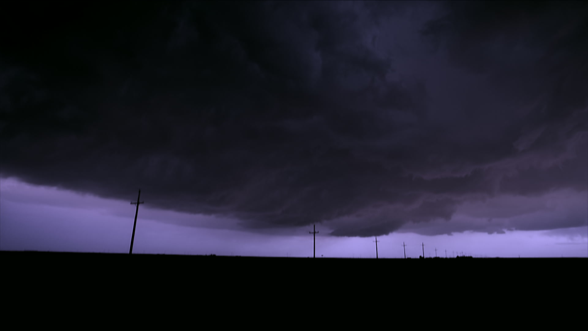 Dark clouds and lightning over rural area at night - Super 35mm film to HD 1080.