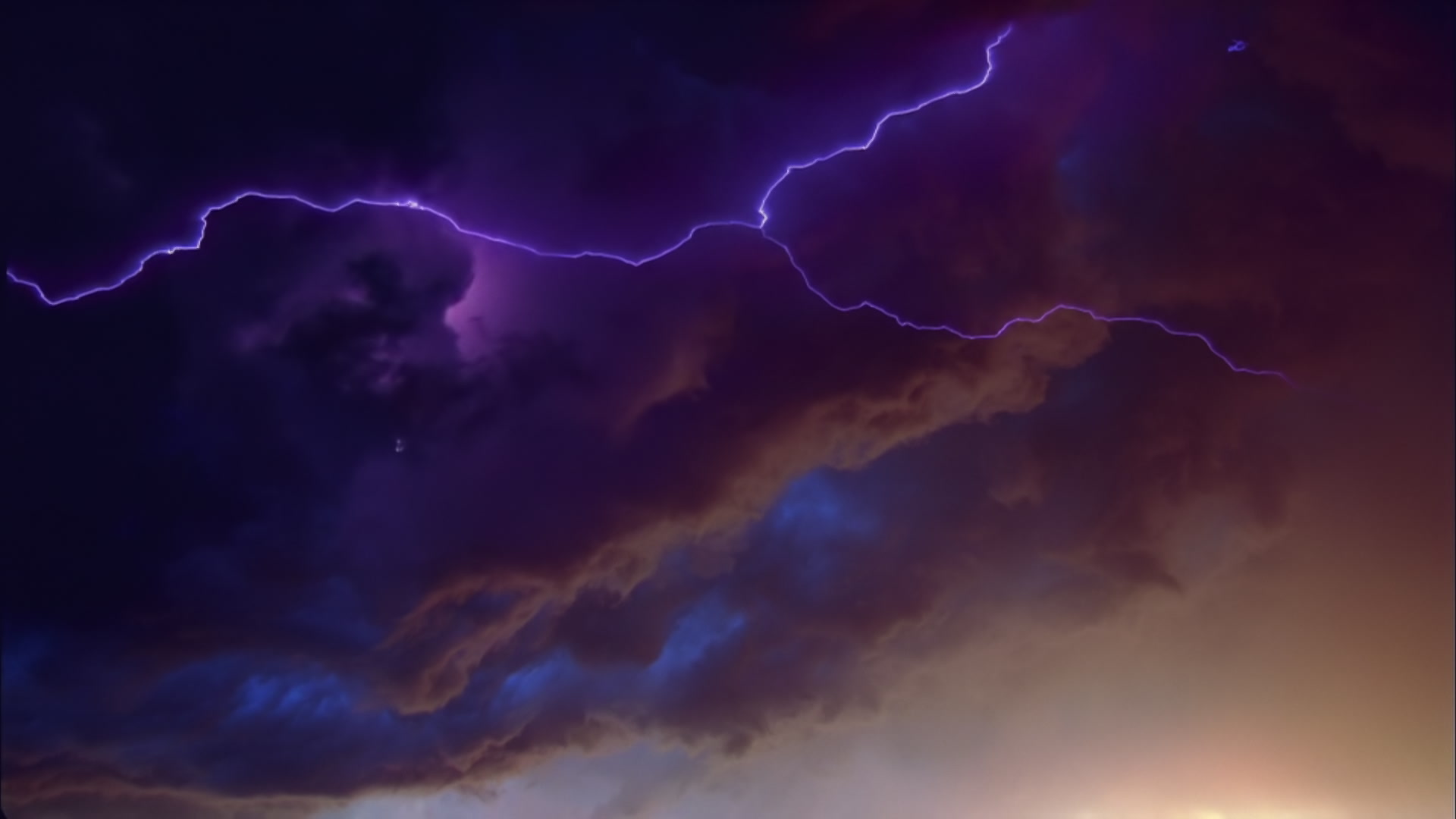 Scary, churning storm clouds with lightning at dusk - Super 35mm film to HD 1080.